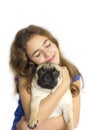 Dog pug looks surprised. Girl hugs her dog with love Royalty Free Stock Photo