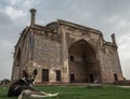 Dog relaxing in front of famous funerary monument