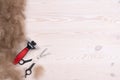 Dog`s hair and a pet comb with scissors on a wooden background after trimming a dog Royalty Free Stock Photo