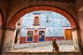 Dog sitting under arch in Bernal, Queretaro, Mexico