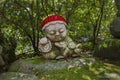 Dog - symbol of japanese horoscope. Jizo stone statue wearing knitted and cloth hats.