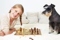 The dog teaches the child to play chess. Royalty Free Stock Photo
