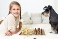 The dog teaches the child to play chess. Royalty Free Stock Photo