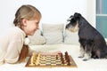 The dog teaches the child to play chess. Your move Royalty Free Stock Photo