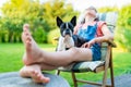 Dog and teenage girl resting in the garden