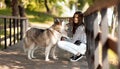 Dog training and education. A girl with a husky in the park, an clever and obedient puppy