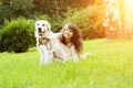 Dog training. Girl with retriever playing in the park. Woman walking a pet on a background summer The landscape. Joyful summer sc