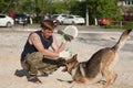 Dog on a walk with the owner in the summer. Walk with a loyal friend of the German Shepherd. Summer evening on a walk with a frien