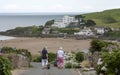 Dog walkers on coast at Bigbury on Sea, Devon, UK