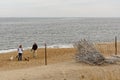 Dog walkers on Salisbury Beach, Massachusetts