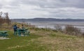 Dog Walkers and their Dog taking a brief rest on one of the Picnic Tables at the Riverside Nature Trail in Dundee. Royalty Free Stock Photo