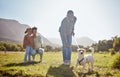 Dog, walking and family relax together in nature park enviroment. Black family, pet and father walk puppy in garden with