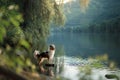 Dog on the water. Summer with a pet. Australian Shepherd at river Royalty Free Stock Photo