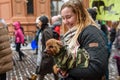 Dog in a winter jacket at owner`s hands, during `March for animals` in Riga, Latvia.