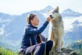 Dog with a woman walking mountains outdoors Royalty Free Stock Photo