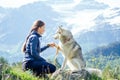 Dog with a woman walking mountains outdoors Royalty Free Stock Photo