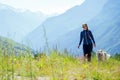 Dog with a woman walking mountains outdoors Royalty Free Stock Photo