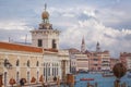 The Dogana da Mar building with two statues of Atlas holding a golden globe at the tip of an island in the Dorsoduro district wi