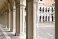 Doge`s Palace or Palazzo Ducale in Venice, Italy. It is famous landmark of Venice. Nice old Gothic colonnade of courtyard Royalty Free Stock Photo