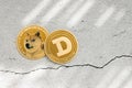 Dogecoin on a light background, top view, the sun's rays shine on the coins, stone background