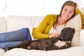Dogs are a joy to own. Portrait of an attractive young woman petting her dog on the sofa. Royalty Free Stock Photo