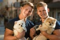 Dogs make life better. Happy twins with muscular look. Spitz dogs love the company of their family. Happy family on walk Royalty Free Stock Photo