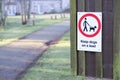 Dogs must be kept on a lead or leash in public park play area sign on entrance gate Royalty Free Stock Photo