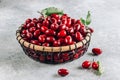 Dogwood berry in a basket. Ripe red cornel on light gray background Royalty Free Stock Photo