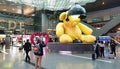 Doha airport interior with a yellow bear figure