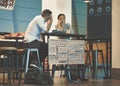 Beautiful young couple sitting in an airport cafe