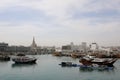 Traditional dhows moored up by Doha corniche