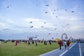 Spectators enjoy the large kites flying at Mina district in Qatar as part of Kite Festival 2024 Royalty Free Stock Photo