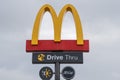 Close up of the McDonald`s Golden Arches logo and drive thru sign