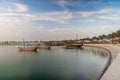 Doha skyline seen from MIA park and three dhow boats in the foreground. Royalty Free Stock Photo