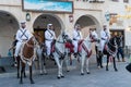 Doha, Qatar - Oct 17, 2022: Tourist police in traditional Qatari dress patrolling along the walkway in Souq Wakif.