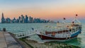 Doha Qatar skyline with traditional Qatari Dhow boats in the harbor Royalty Free Stock Photo