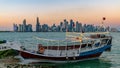 Doha Qatar skyline with traditional Qatari Dhow boats in the harbor Royalty Free Stock Photo