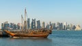 Doha Qatar skyline with traditional Qatari Dhow boats in the harbor Royalty Free Stock Photo