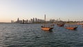Doha Qatar skyline with traditional Qatari Dhow boats in the harbor Royalty Free Stock Photo