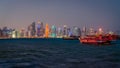 Doha Qatar skyline with traditional Qatari Dhow boats in the harbor Royalty Free Stock Photo