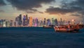 Doha Qatar skyline with traditional Qatari Dhow boats at night in the harbor Royalty Free Stock Photo