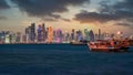 Doha Qatar skyline with traditional Qatari Dhow boats in the harbor Royalty Free Stock Photo