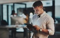 Doing it all with utmost efficiency. a young businessman using a digital tablet in an office at night. Royalty Free Stock Photo