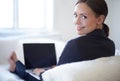 Doing business with a relaxed attitude. Attractive young businesswoman working on her laptop at home. Royalty Free Stock Photo