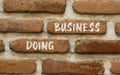 Doing business symbol. Concept words Doing business on beautiful brown bricks. Beautiful brick wall background. Beautiful brick Royalty Free Stock Photo