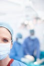 Doing everything possible. Cropped closeup of a mature female surgeon wearing hospital scrubs and a protective face mask