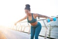 Plump tattooed woman feeling satisfied while doing exercises