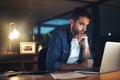 Doing the final check. a handsome young businessman working late at night on his computer in a modern office. Royalty Free Stock Photo