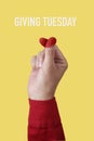 doing finger heart gesture and text giving tuesday