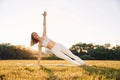 Doing hands practive. Beautiful woman in sportive clothes doing fitness exercises outdoors on the field